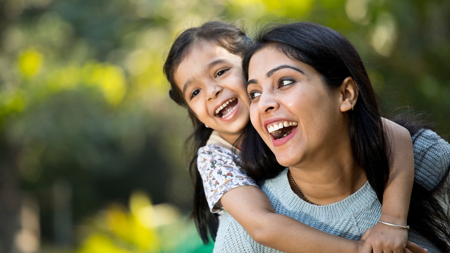 Mom plays with daughter outside